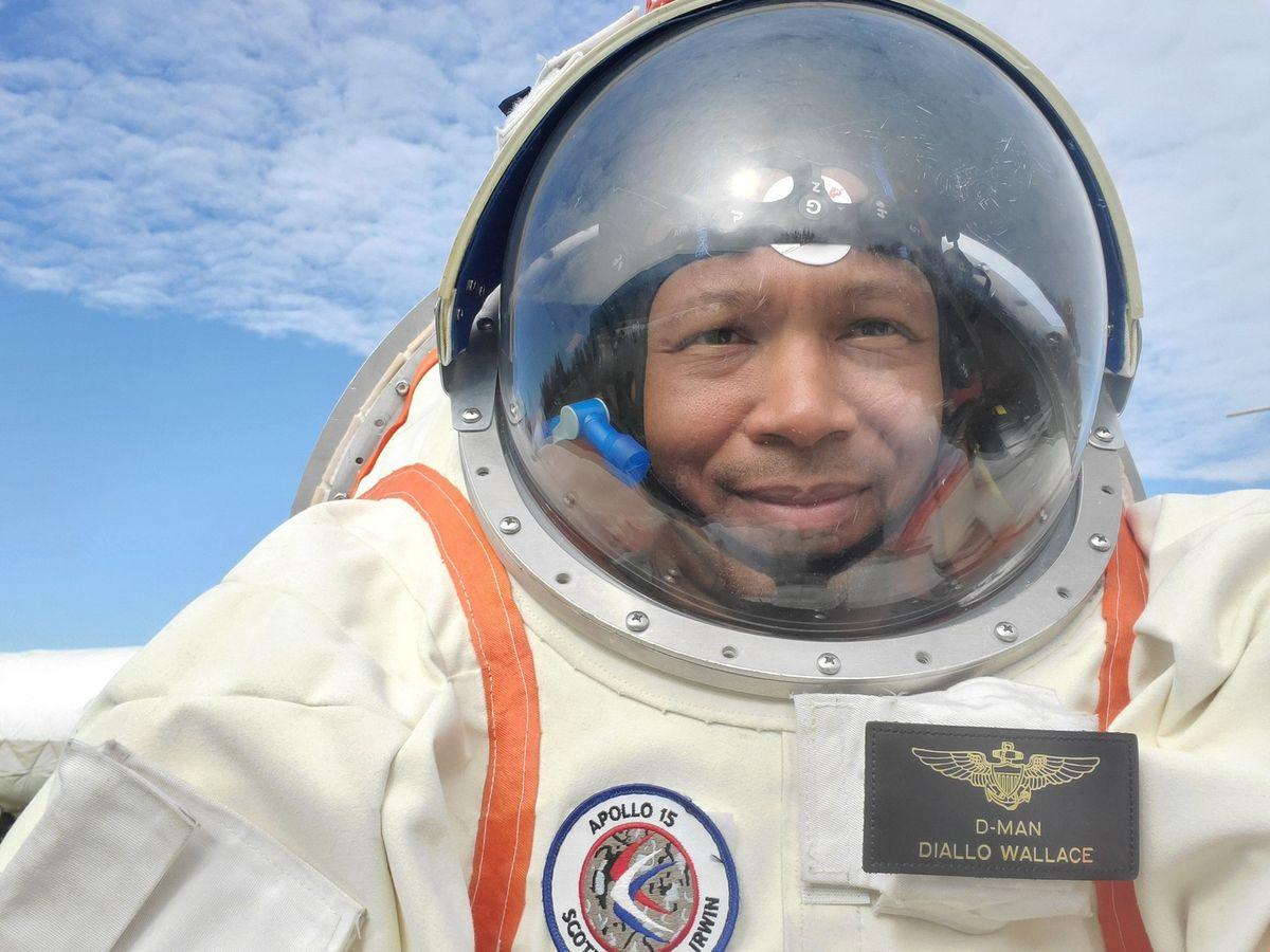 Diallo Wallace selfie in spacesuit with Earth-like sky background